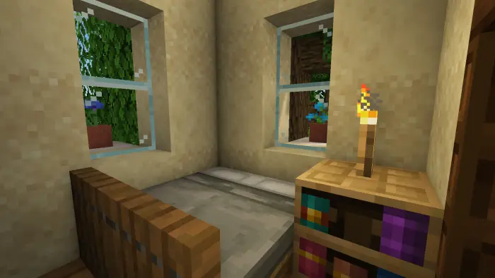 Cozy bedroom with bed, bookshelf, and torch