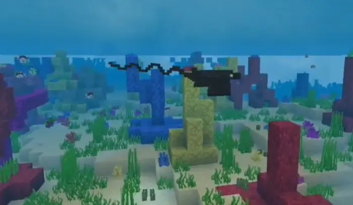 Blocky bat ray swims above colorful seabed