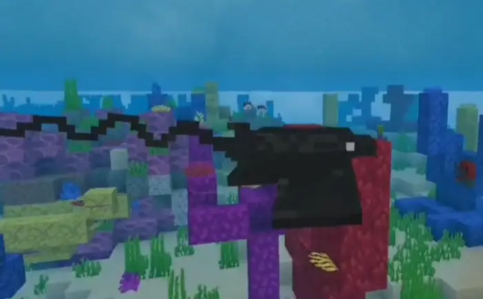 Blocky bat ray swims among colorful corals
