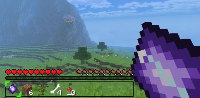 Player holding purple item in open grassy world