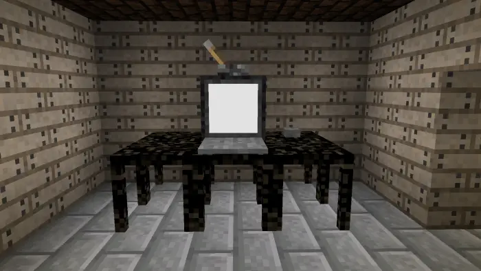 Computer on a dark table in a dim room