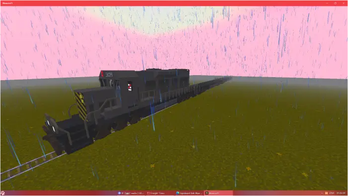 Blocky freight train on grassy terrain in rain
