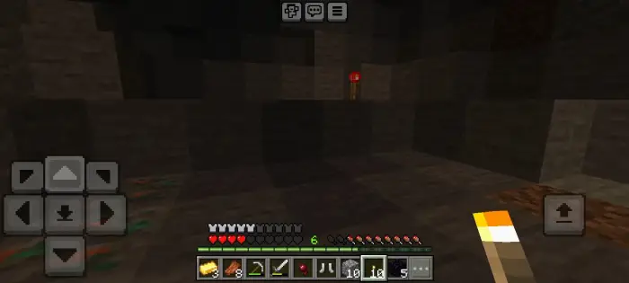 Dark cave with eerie redstone torch.