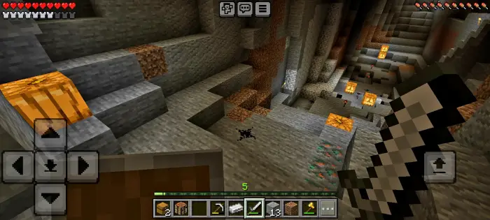 Creepy cavern with glowing pumpkins and sword