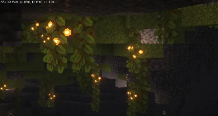 Glowing vines hang from smooth cave walls.