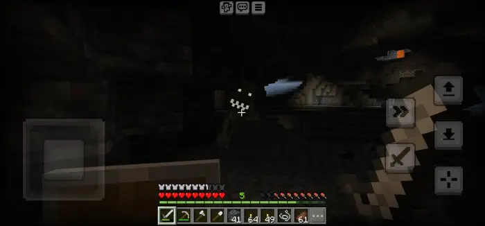 Player faces eerie creature in dark cavern.