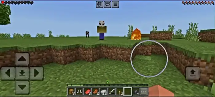 Humanoid entity stands near fire on grass.