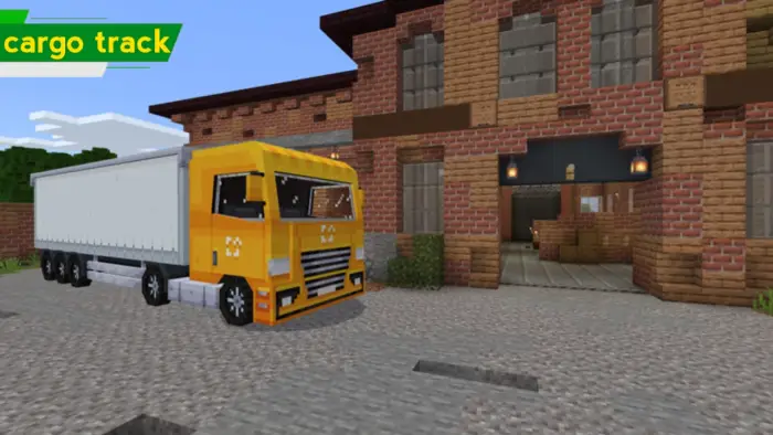 Blocky yellow truck parked by brick building