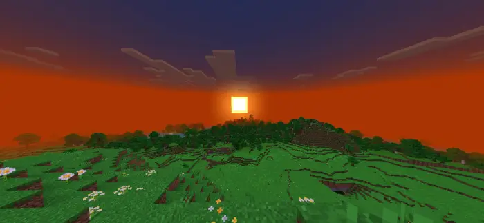 Vivid sunset over stylized grassy landscape