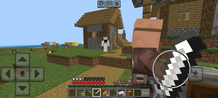 A ghostly figure appears near village houses.