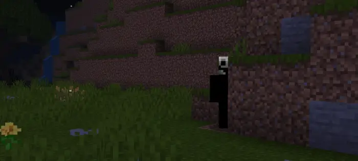 Spooky figure lurking behind hillside at night