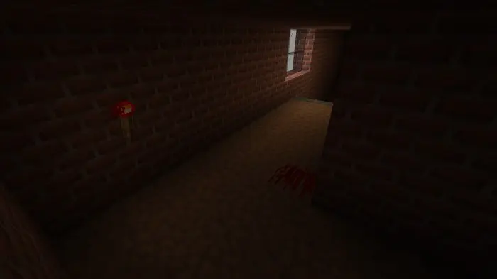 Dimly lit brick hallway with bloodstain.