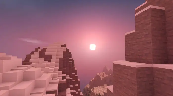 Pink sunset over blocky snowy mountains