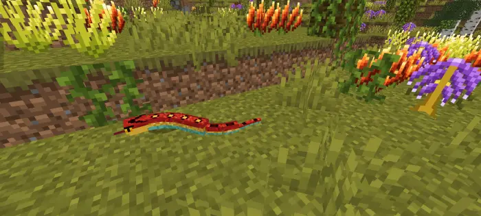 Colorful snake among vibrant flowers and grass