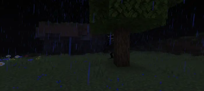 Shadowy creature lurking behind a tree at night