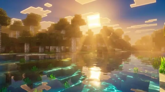 Sun rays shining over a reflective lake