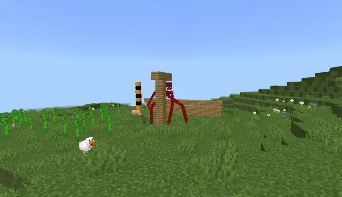 Giant red mimic creature among grass blocks