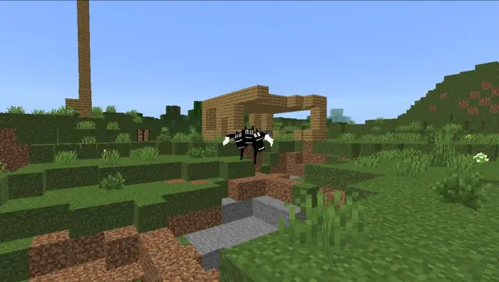 Three-headed creature near a wooden shelter