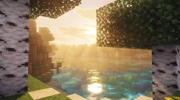 Golden sun rays shine over a reflective lake
