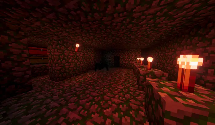 Mossy stone dungeon lit by red torches