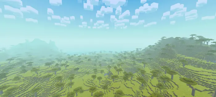 Savanna hills and trees under a cloudy sky