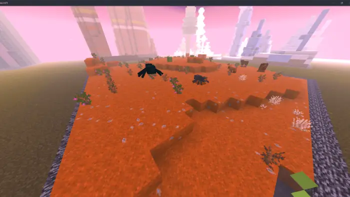 Orange terrain with plants under pink sky